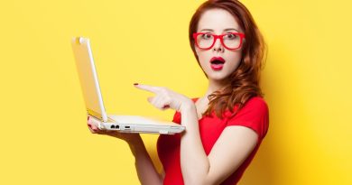a girl in red dress holding a laptop